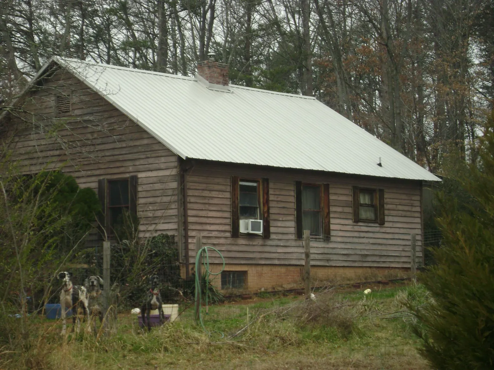 White metal roof on an old wood sided farmhouse, from a Metal Roof Installation job in East Moline